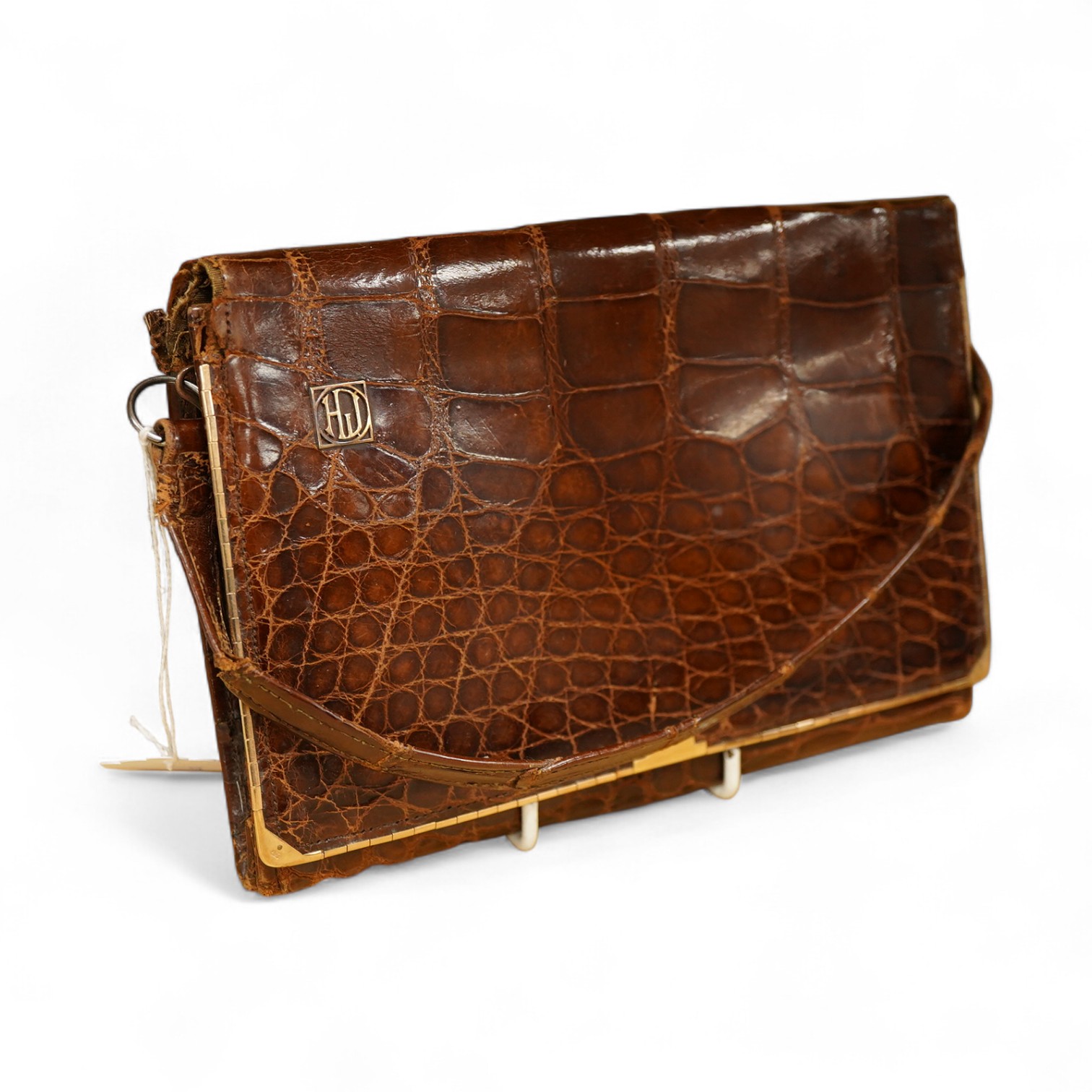 A stylish 1930's ladies 9ct gold mounted brown crocodile handbag, fitted with small wallet and mirror, 21.5cm wide x 15cm high. Condition - the corners to base, top and handle have wear, the silk lining has a small split